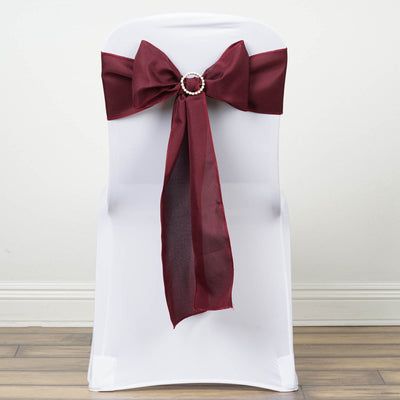 Burgundy chair sash with rhinestone buckle on a white chair