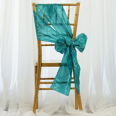 Teal satin chair sash tied in a bow on a gold chiavari chair.