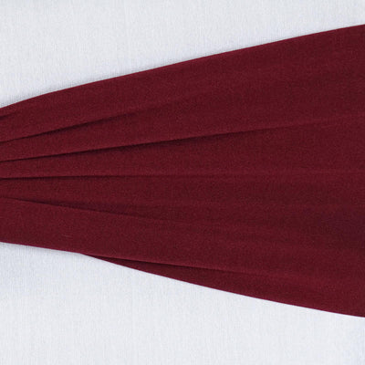 Burgundy fabric with pleats on a white background