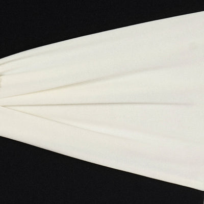 White fabric draped elegantly on a black background.