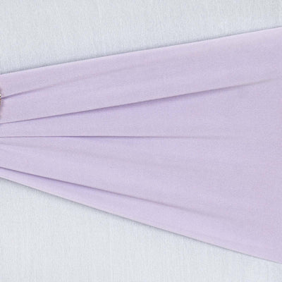 Lavender fabric draping elegantly with a decorative pin.