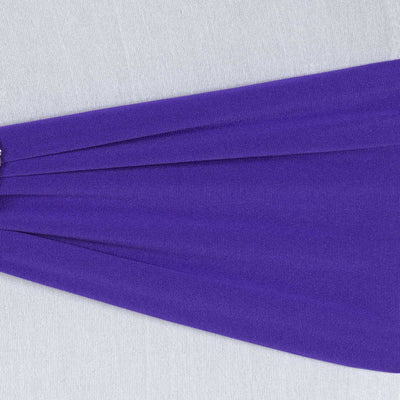 Purple fabric draped elegantly on a light gray background.