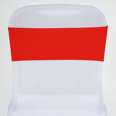 Red chair cover on a white chair for event decoration.