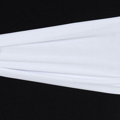 White fabric draped elegantly on a black surface.