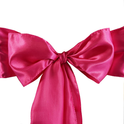 Pink satin bow with a glossy finish, tied in a decorative knot.