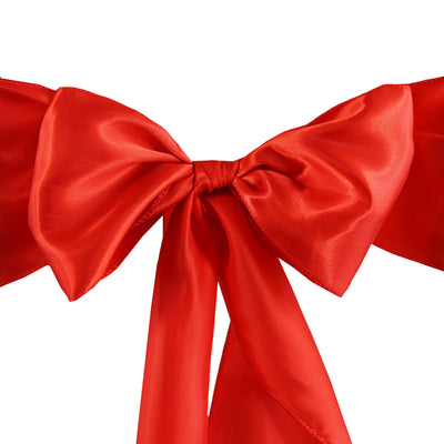 Red satin bow with long ribbons on a white background