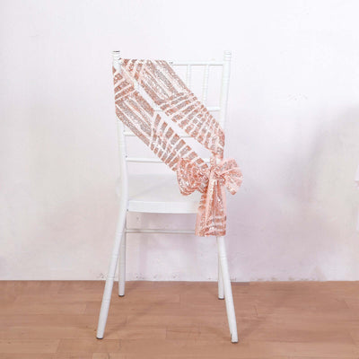 Rose gold sequin chair sash tied on a white chair.