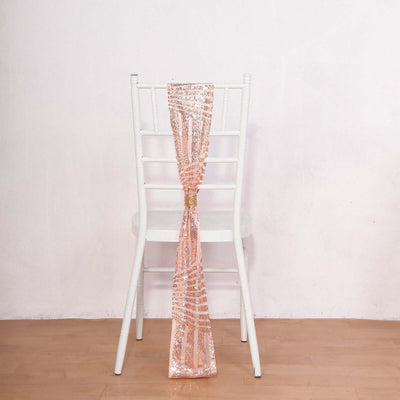 Rose gold sequin chair sash draped on a white chair against a plain backdrop.