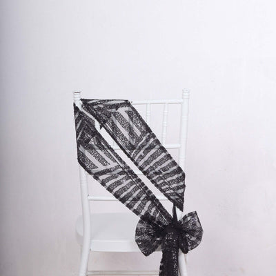 Black lace chair sash draped elegantly on a white chair.