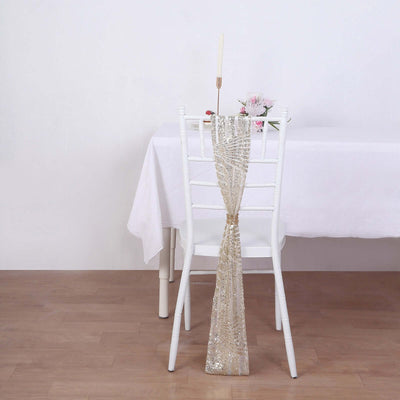 Elegant gold sequin chair sash on a white chair in a minimalist setting.