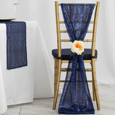 Navy sequin chair sash with flower decoration on a gold chiavari chair.