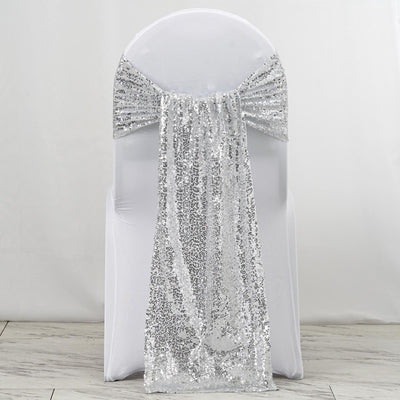 Silver sequin chair sash draped elegantly over a white chair.