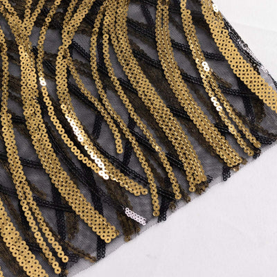 Black mesh fabric with gold sequin wave pattern.