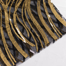 A close up of glittering sequin chair sashes made of black and gold sequin on mesh base with a sparkly wave pattern