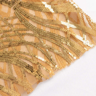 Gold sequin fringe on a sheer fabric background.