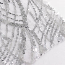 a close up of glittering silver sequin chair sashes on a white background