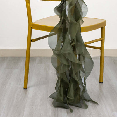Olive green ruffled fabric draped over a yellow chair.