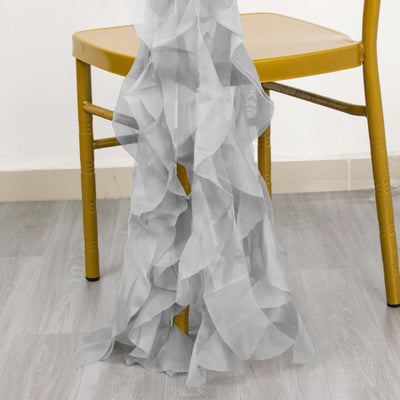 Sheer gray ruffle fabric draped over a chair.