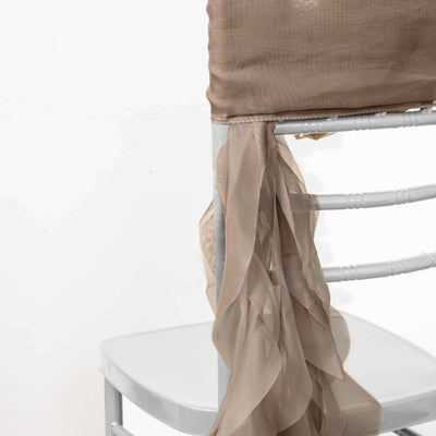 Elegant chair cover with flowing beige fabric drapes.