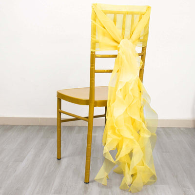 Yellow chair with a flowing yellow ribbon tied at the back.