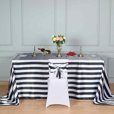Striped tablecloth with decorative accessories for elegant dining setup.