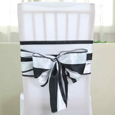Black and white striped chair sash tied in a bow on a white chair.