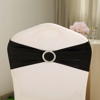Black chair cover with rhinestone buckle accent.
