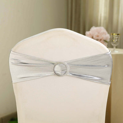 Silver chair cover sash with rhinestone buckle for elegant decor.