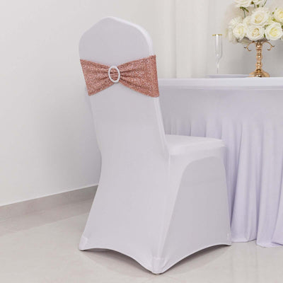 White chair cover with sparkling rose gold bow at a decorated table