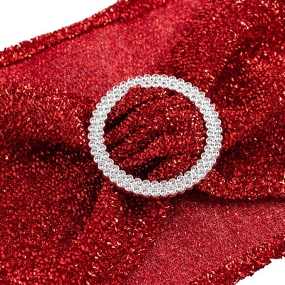 Sparkling silver circular brooch on red glitter fabric