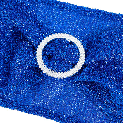 Blue sparkly fabric with a circular rhinestone embellishment.