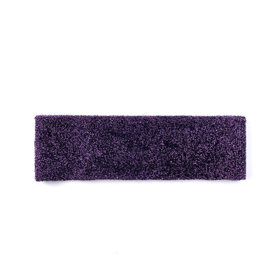 Purple cleaning sponge on a white background.
