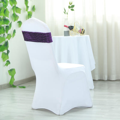 White chair cover with purple sash in a decorated setting.