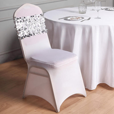 Elegant chair cover with sequin detail against a dining table.