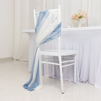 White chair draped with blue and white fabric in elegant setting.