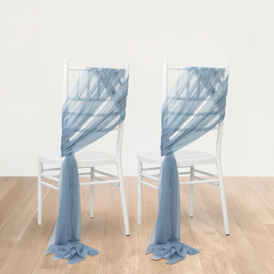 Blue chiffon chair sashes elegantly draped on white chairs.