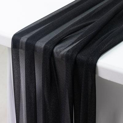 Black sheer fabric draped elegantly over a table edge.