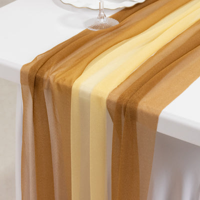 Sheer gold and yellow table runner draped on a white table.