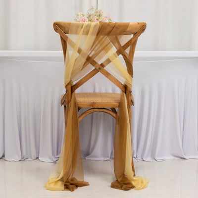 Wooden chair draped with yellow and brown sheer fabric, set against a light backdrop.