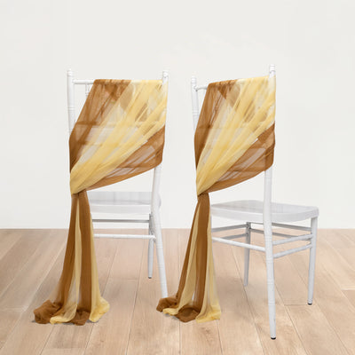 Two chairs draped with yellow and brown chiffon fabric.