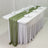 Elegant green table runner on a white table set for a formal dining occasion.