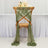 Green sheer fabric draping elegantly from a wooden chair in a styled setting.