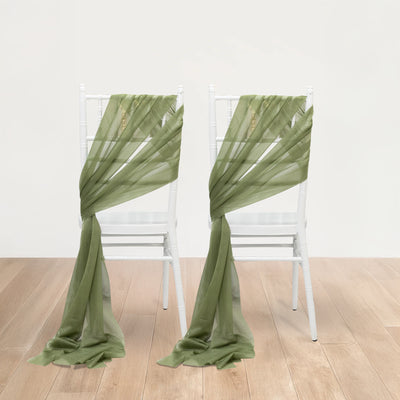Green sheer chair sashes elegantly draped on white chairs