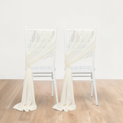 White chair sashes elegantly draped over two white chairs