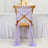 Purple chiffon chair sash draped elegantly on a wooden chair.