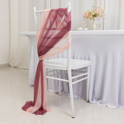 Elegant fabric draped on a chair, featuring soft pink and burgundy colors.