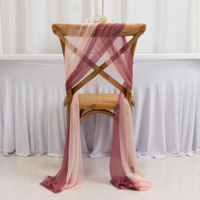 Elegant chair with soft gradient fabric drapes in blush and burgundy colors.