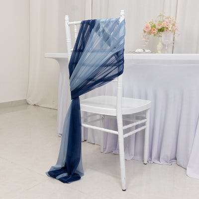 Navy and blue sheer fabric draped over a white chair at an elegant event.