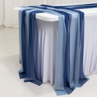 Elegant blue and grey sheer table runners draping over a white table.