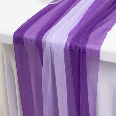 Purple organza table runner draping elegantly over a white table.